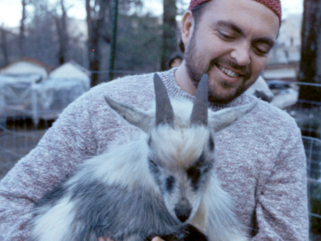 Photo of Adi Da Samraj holding a baby goat