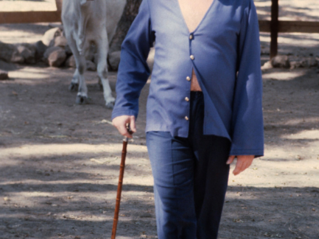 Photo of Adi Da Samraj walking with a white cow with horns behind him