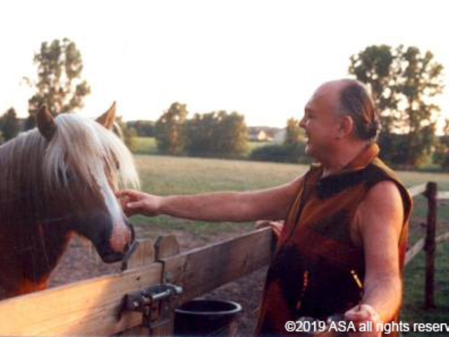Photo of Adi Da Samraj petting a horse and smiling