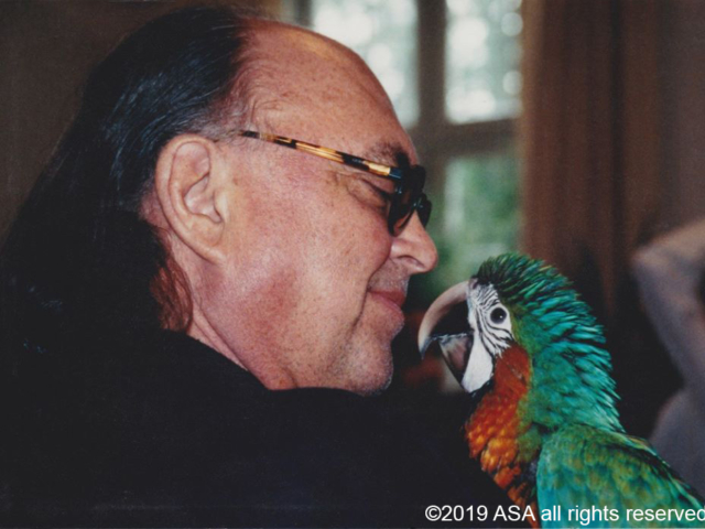 Photo of Adi Da Samraj and a parrot looking at each other