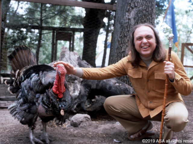 Photo of Adi Da Samraj smiling and petting a turkey